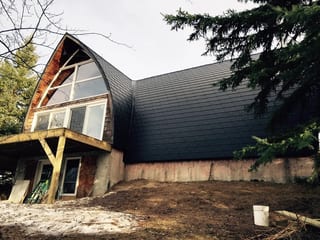 Black Interlock Slate aluminum roof on a forested home with an A-Frame style and metal roof in, Whitecourt, Alberta