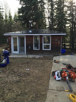 Black Interlock Slate aluminum roof on a brown single-storey home with a black metal roof among, Whitecourt, Alberta