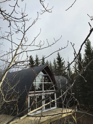 Black Interlock Slate aluminum roof on a black metal roof on a chalet style house in the forest, Whitecourt, Alberta