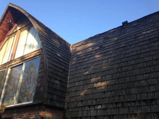 Black Interlock Slate aluminum roof on a black metal roof on a single-family home in a forested, Whitecourt, Alberta