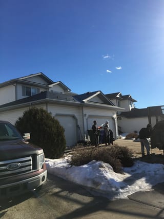 Deep Charcoal Interlock Slate aluminum roof on a white single-family home with a modern roof among snow, Fort Saskatchewan, Alberta