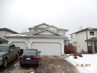 Deep Charcoal Interlock Slate aluminum roof on a white two-storey home with a metal roof in Fort, Fort Saskatchewan, Alberta