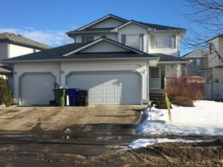 Deep Charcoal Interlock Slate aluminum roof on a two-storey home with metal roof in a rural suburban, Fort Saskatchewan, Alberta