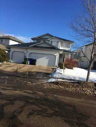 Deep Charcoal Interlock Slate aluminum roof on a white two-storey home with a metal roof in a residential, Fort Saskatchewan, Alberta