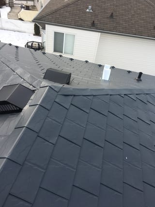 Deep Charcoal Interlock Slate aluminum roof on a two-storey home with a dark roof and white siding in a, Fort Saskatchewan, Alberta
