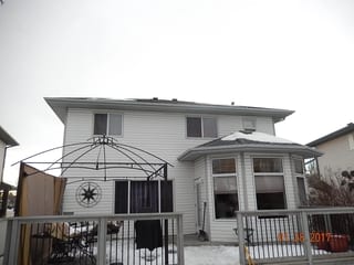 Deep Charcoal Interlock Slate aluminum roof on a white two-storey home with a metal roof in rural Alberta, Fort Saskatchewan, Alberta