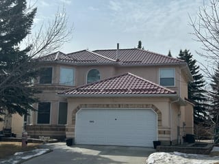 Tile Red Interlock Tile aluminum roof on a tan house with a tile red metal roof in Calgary, Alberta, Calgary, Alberta
