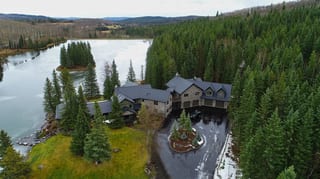 Black Interlock Shake aluminum roof on a two-storey chalet in a forested mountain setting, Bragg Creek, Alberta