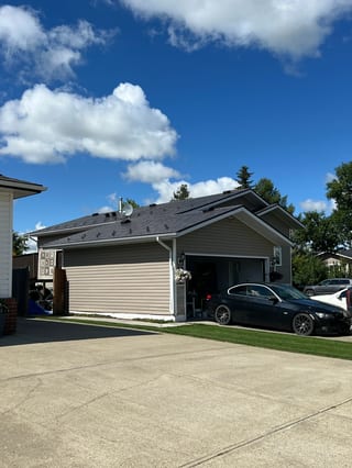 Tudor Brown Interlock Slate aluminum roof on a Tudor Brown metal roof on a ranch-style home in a, Legal, Alberta