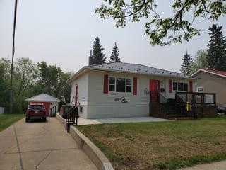 Black Interlock Slate aluminum roof on a white ranch-style home with a metal roof in a suburban, Fort Saskatchewan, Alberta