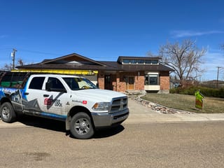 Colonial Brown Interlock Slate aluminum roof on a brown single-storey home with a metal roof in a rural, Oyen, Alberta