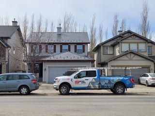 Deep Charcoal Interlock Slate aluminum roof on a two-storey modern home with dormers in a mountainous, Calgary, Alberta
