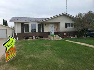 Colonial Brown Interlock Slate aluminum roof being installed on a Colonial brown metal roof on a single-storey rural home, Vegreville, Alberta