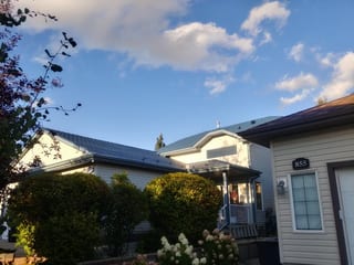 Royal Blue Interlock Slate aluminum roof on a beige bungalow with a metal roof in a rural, suburban, Devon, Alberta