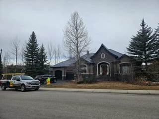 Deep Charcoal Interlock Slate aluminum roof on a grey one-storey home with dormers in the mountains, Calgary, Alberta