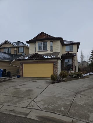Colonial Brown Interlock Slate aluminum roof on a Colonial brown two-storey home with a brown roof among, Calgary, Alberta