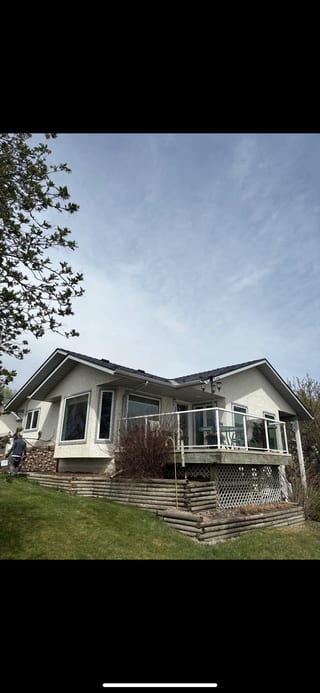 Deep Charcoal Interlock Slate aluminum roof on a white ranch home with a metal roof in a rural setting, Red Deer County, Alberta