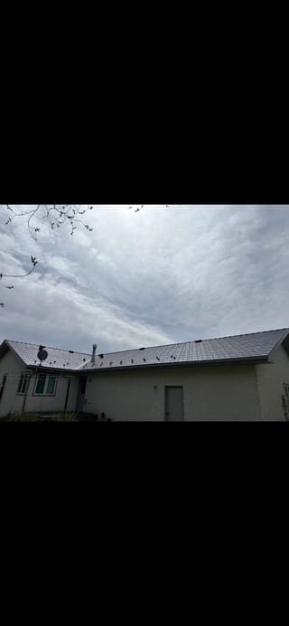 Deep Charcoal Interlock Slate aluminum roof on a beige one-storey home with dormers in a rural setting, Red Deer County, Alberta