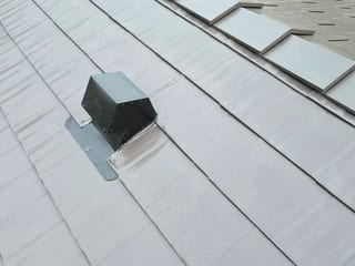 Tudor Brown Interlock Cedar Shingle aluminum roof on a Tudor-style home with a metal roof in the mountains, Rocky Mountain House, Alberta