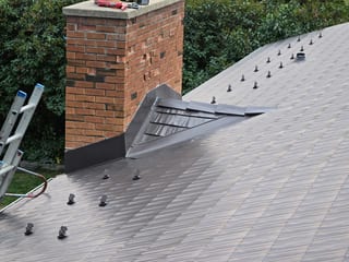 Interlock Aluminum Cedar Shingle Metal Roofing – Tudor Brown | Rocky Mountain House, AB (Chimney flashing detail)