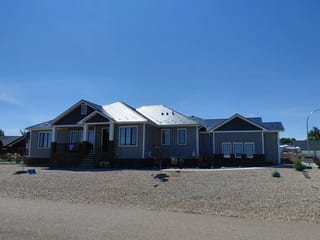 Deep Charcoal Interlock Slate aluminum roof on a single-storey home with a metal roof in a rural area, Dunmore, Alberta