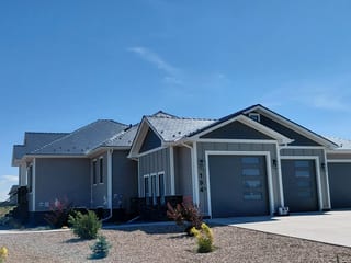 Deep Charcoal Interlock Slate aluminum roof on a grey ranch-style home with a metal roof in a rural area, Dunmore, Alberta