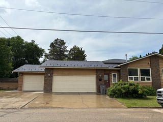Black Interlock Slate aluminum roof on a brown ranch home with a metal roof in a rural suburban, Grande Prairie, Alberta