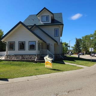 Hunter Green Interlock Cedar Shingle aluminum roof on a two-storey home with a green metal roof in Sylvan Lake,, Sylvan Lake, Alberta