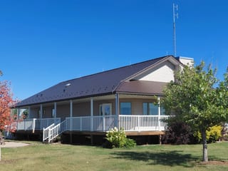 Colonial Brown Interlock Cedar Shingle aluminum roof on a Colonial brown metal roof on a one-storey home with a, Delia, Alberta