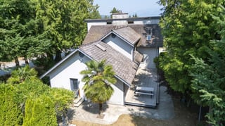 Before: a mossy wood shake roof on the home, Sechelt, British Columbia, ahead of a Deep Charcoal Interlock Slate aluminum roof