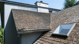 Before: a mossy wood shake roof on the home, Sechelt, British Columbia, ahead of a Deep Charcoal Interlock Slate aluminum roof