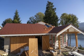 Copper Penny Interlock Slate aluminum roof being installed on a two-storey home with copper penny metal roof on waterfront, Sechelt, British Columbia