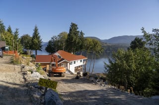 Copper Penny Interlock Slate aluminum roof being installed on the home, replacing new construction, Sechelt, British Columbia