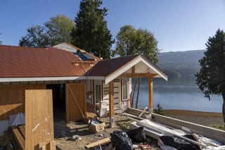 Copper Penny Interlock Slate aluminum roof being installed on a house with a metal roof on the waterfront, replacing new construction, Sechelt, British Columbia