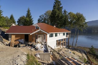 Copper Penny Interlock Slate aluminum roof being installed on the home, replacing new construction, Sechelt, British Columbia