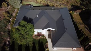 Deep Charcoal Interlock Slate aluminum roof on a large, single-storey home with an Interlock Slate metal, West Kelowna, British Columbia