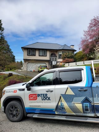 Deep Charcoal Interlock Slate aluminum roof being installed on the home, replacing a worn out asphalt shingle roof, Gibsons, British Columbia