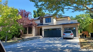 Black Interlock Slate aluminum roof on a modern home with a metal roof in a forested rural setting, Kelowna, British Columbia