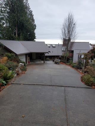 Tudor Brown Interlock Slate aluminum roof on a Tudor style house with brown Interlock Slate metal roof, Roberts Creek, British Columbia