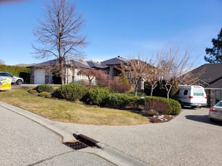 Tudor Brown Interlock Cedar Shingle aluminum roof on a Tudor brown single-family home in a suburban setting, West Kelowna, British Columbia