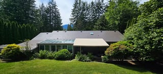 Tudor Brown Interlock Slate aluminum roof on a Tudor brown metal roof on a one-storey home among, Squamish, British Columbia