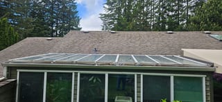 Before: a mossy asphalt shingle roof on the home, Squamish, British Columbia, ahead of a Tudor Brown Interlock Slate aluminum roof
