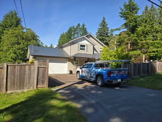 Deep Charcoal Interlock Slate aluminum roof on a home with a metal roof in a wooded area, Gibsons, British Columbia