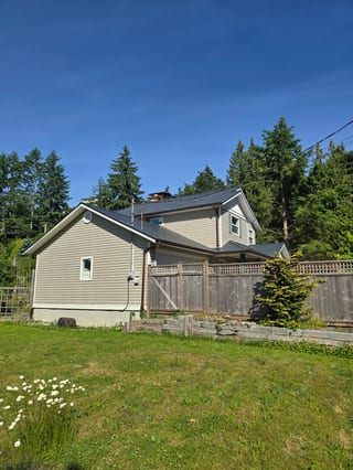 Deep Charcoal Interlock Slate aluminum roof on a two-storey home with Interlock Slate metal roof in Deep, Gibsons, British Columbia