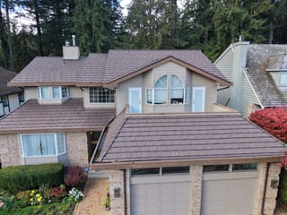 Colonial Brown Interlock Shake aluminum roof on a two-storey Colonial home with a brown roof in a forested, North Vancouver, British Columbia