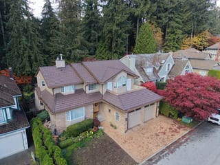 Colonial Brown Interlock Shake aluminum roof on a colonial style home with a brown roof among evergreens, North Vancouver, British Columbia