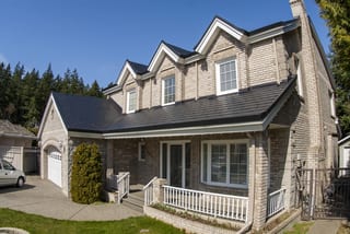 Black Interlock Slate aluminum roof on a colonial home with a slate metal roof in a forested, Surrey, British Columbia