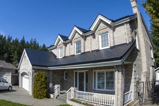 Black Interlock Slate aluminum roof on a two-storey home with dormers and Interlock Slate metal, Surrey, British Columbia