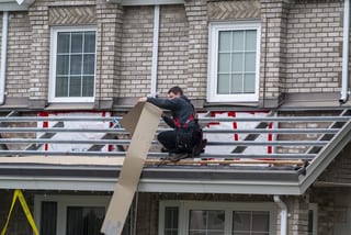 Black Interlock Slate aluminum roof being installed on the home, replacing a metal roof with broken tiles, Surrey, British Columbia