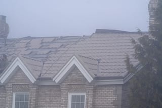 Black Interlock Slate aluminum roof being installed on the home, replacing a worn out metal roof, Surrey, British Columbia